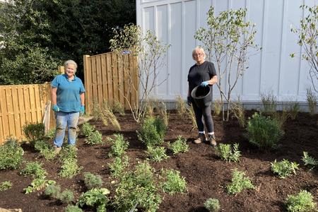 two-women-standing-in-garden